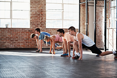 Buy stock photo Shot of a group of people stretching in a fitness class