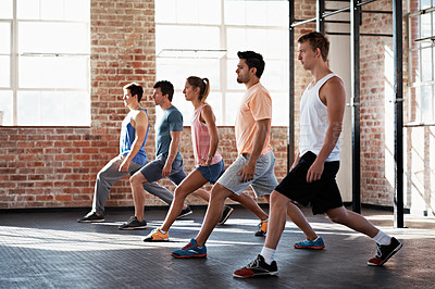 Buy stock photo Shot of a group of people doing a fitness class