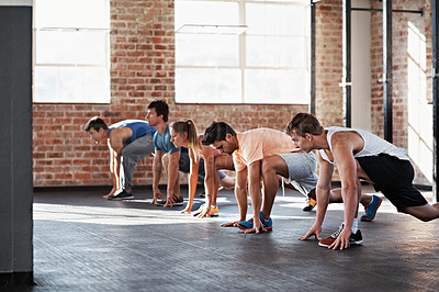 Buy stock photo Shot of a group of people doing a fitness class