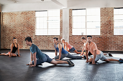 Buy stock photo Shot of a group of people stretching in a fitness class