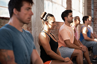 Buy stock photo Shot of a group of people lined up against the wall in a fitness class