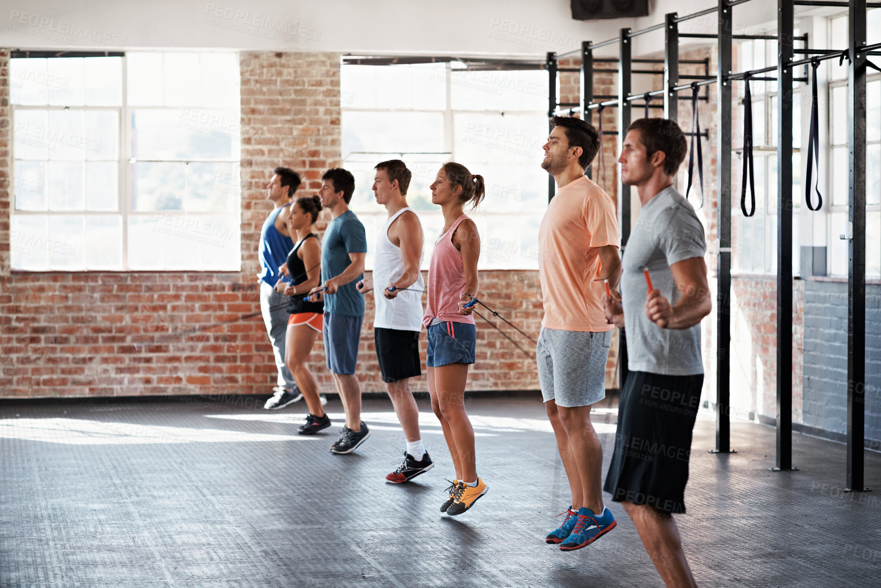 Buy stock photo Fitness, workout and jump rope with people in gym for training, health and sports exercise. Wellness class, athlete and skipping with bodybuilder group for core muscle, coaching and endurance