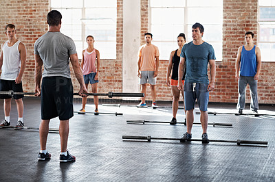 Buy stock photo Shot of a group of people doing a fitness workout with bars