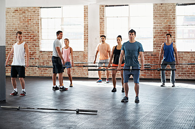 Buy stock photo Shot of a group of people doing a fitness workout with bars