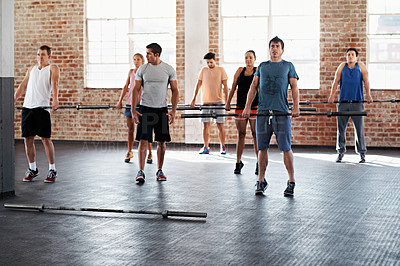 Buy stock photo Shot of a group of people doing a fitness workout with bars