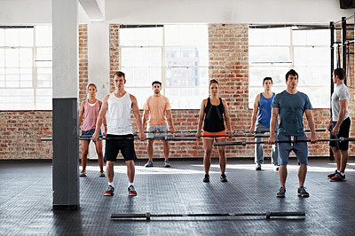 Buy stock photo Shot of a group of people doing a fitness workout with bars