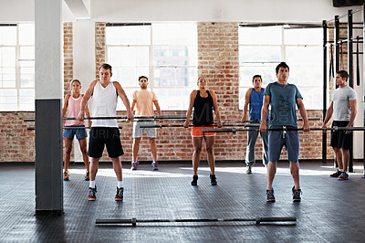 Buy stock photo Shot of a group of people doing a fitness workout with bars