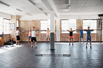 Buy stock photo Shot of a group of people doing a fitness workout with bars