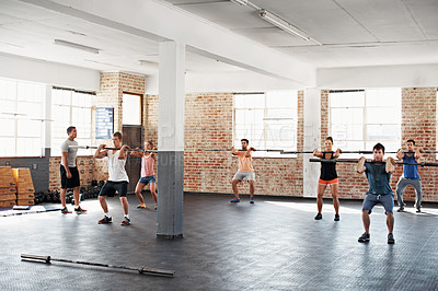 Buy stock photo Shot of a group of people doing a fitness workout with bars