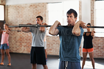 Buy stock photo Shot of a group of people doing a fitness workout with bars