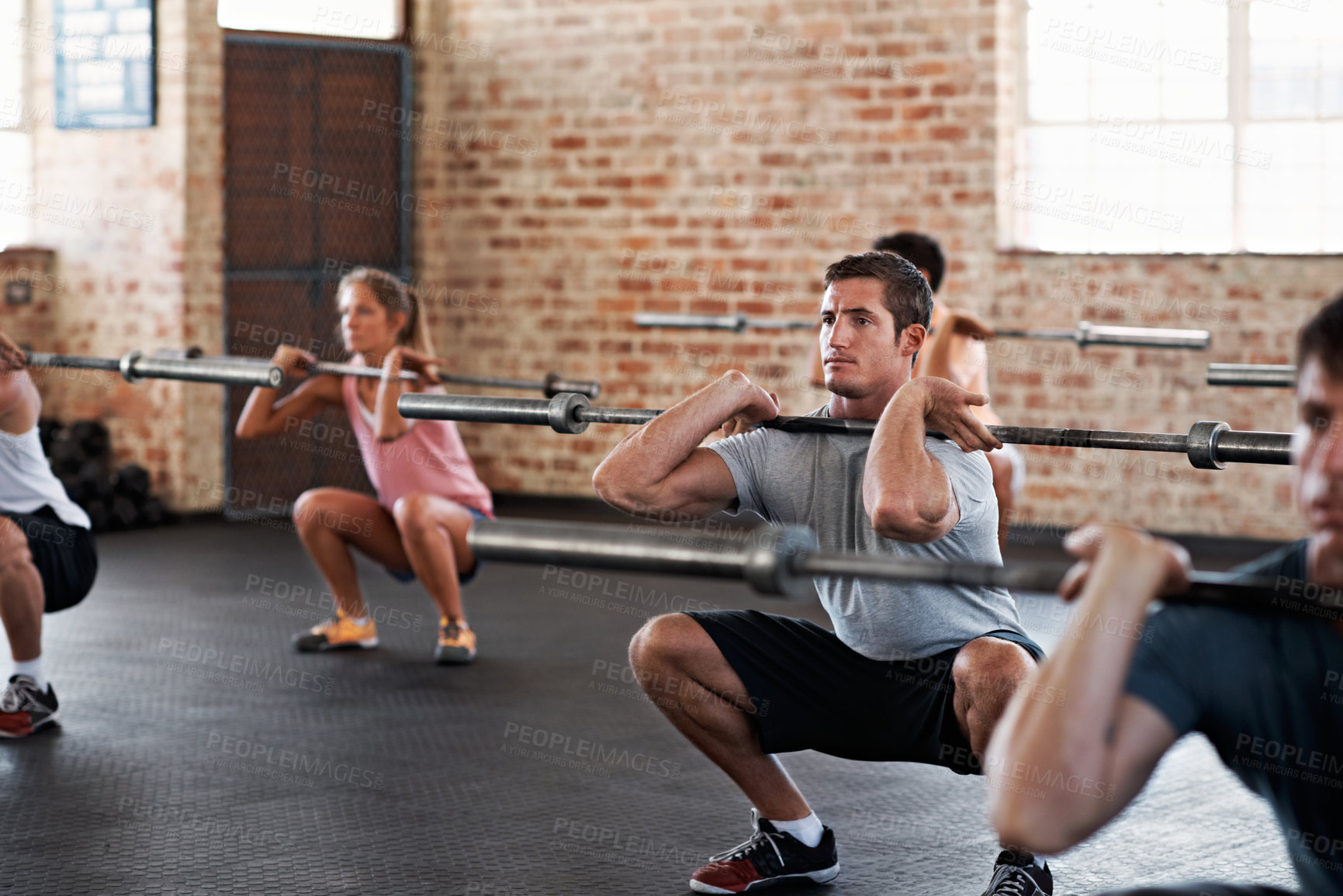 Buy stock photo Group, man and barbell at gym for fitness, exercise and challenge for strength training. Intense, male person and people with equipment for weightlifting, endurance workout and resilience wellness