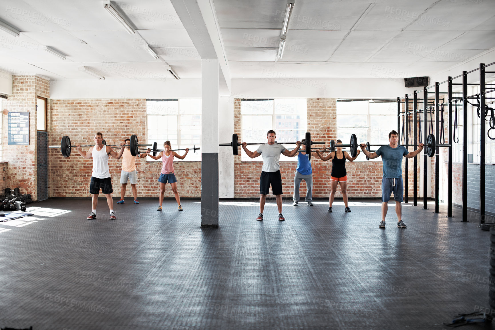 Buy stock photo Fitness, people or barbell in class for workout, health or practice technique for strength benefits. Bodybuilder, group weightlifting or equipment for training, powerlifting or muscle growth at gym