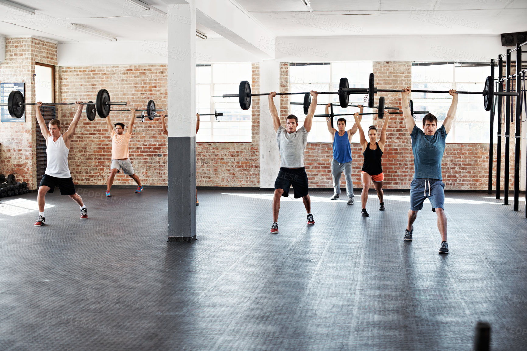 Buy stock photo Fitness, weightlifting or people in class with barbell, bodybuilding or arm exercise in gym session. Serious, team or athletes with equipment, workout challenge or group training for muscle growth.