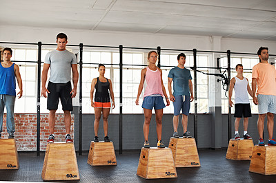Buy stock photo Shot of a group of people standing on boxes in a fitness class