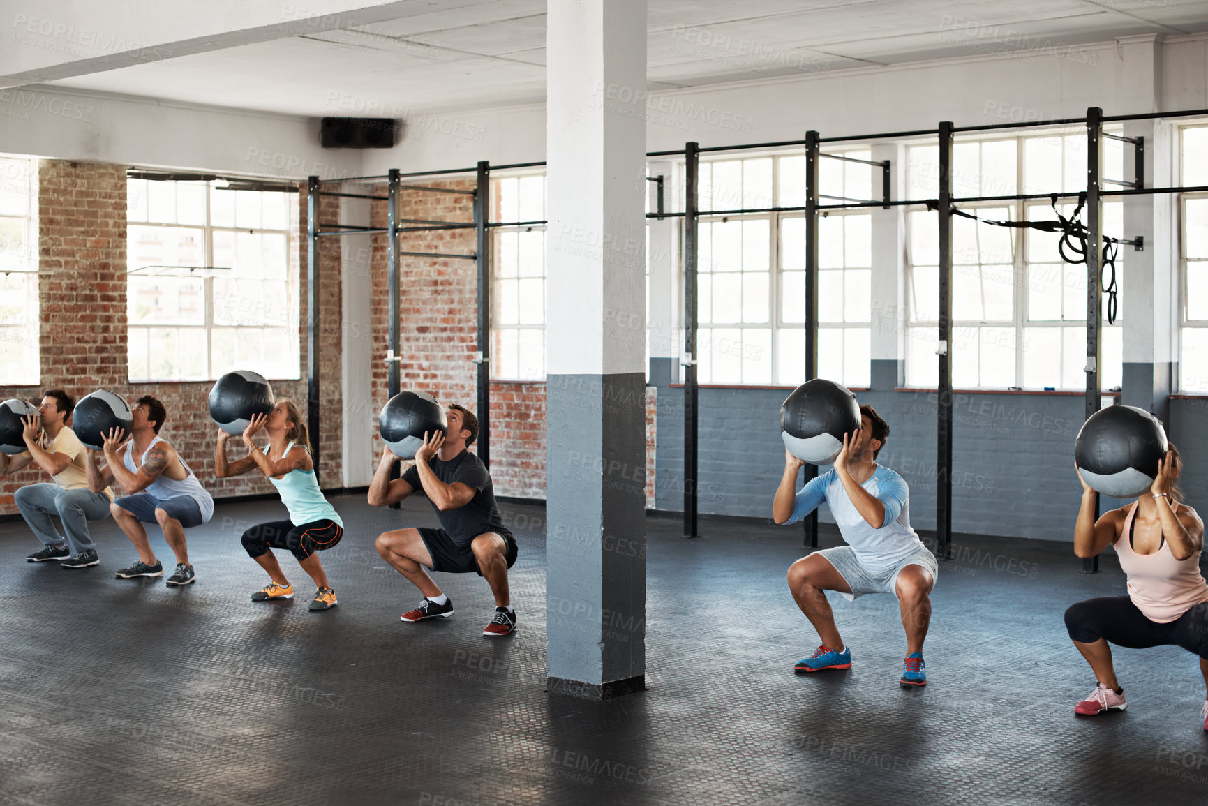 Buy stock photo Fitness, training and medicine ball with people in gym for workout, health and sports exercise. Wellness class, athlete and weights with bodybuilder group for core muscle, coaching and endurance