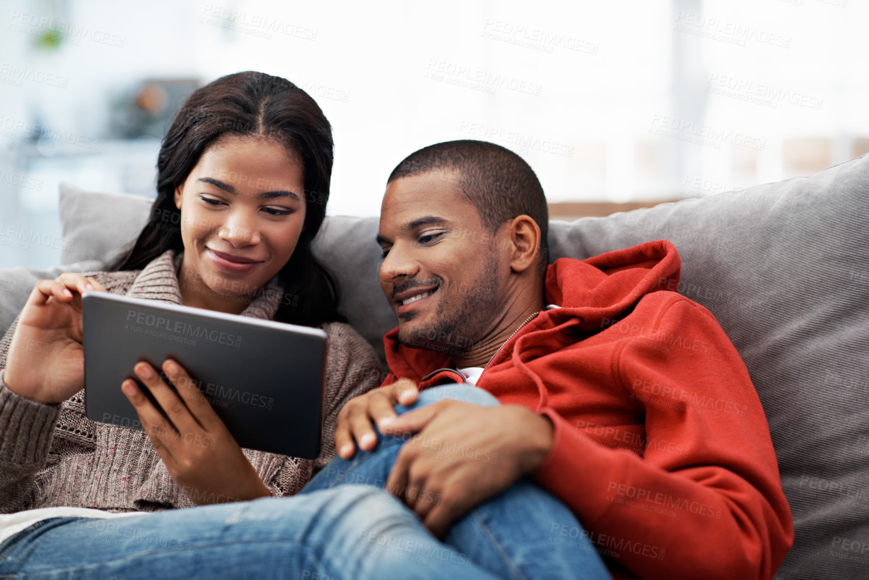 Buy stock photo Relax, tablet and happy couple on couch for love, vacation booking and trip itinerary on weekend. Technology, man and woman in home living room to chill, holiday planning and bonding with partner