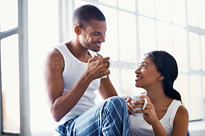 Buy stock photo Cropped shot of a young couple enjoying their morning at home