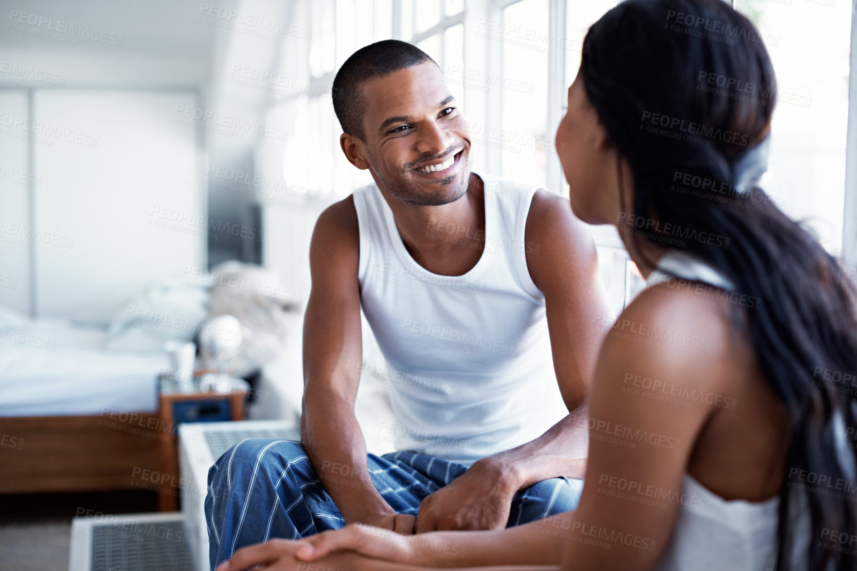Buy stock photo Relax, morning and happy couple in home for conversation, weekend or social interaction together. Man, woman or talking in bedroom with smile, love or care for discussion, romance or chat in house
