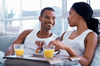 Buy stock photo Cropped shot of a young couple enjoying their morning at home