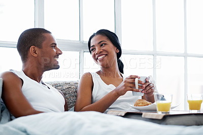 Buy stock photo Cropped shot of a young couple enjoying their morning at home