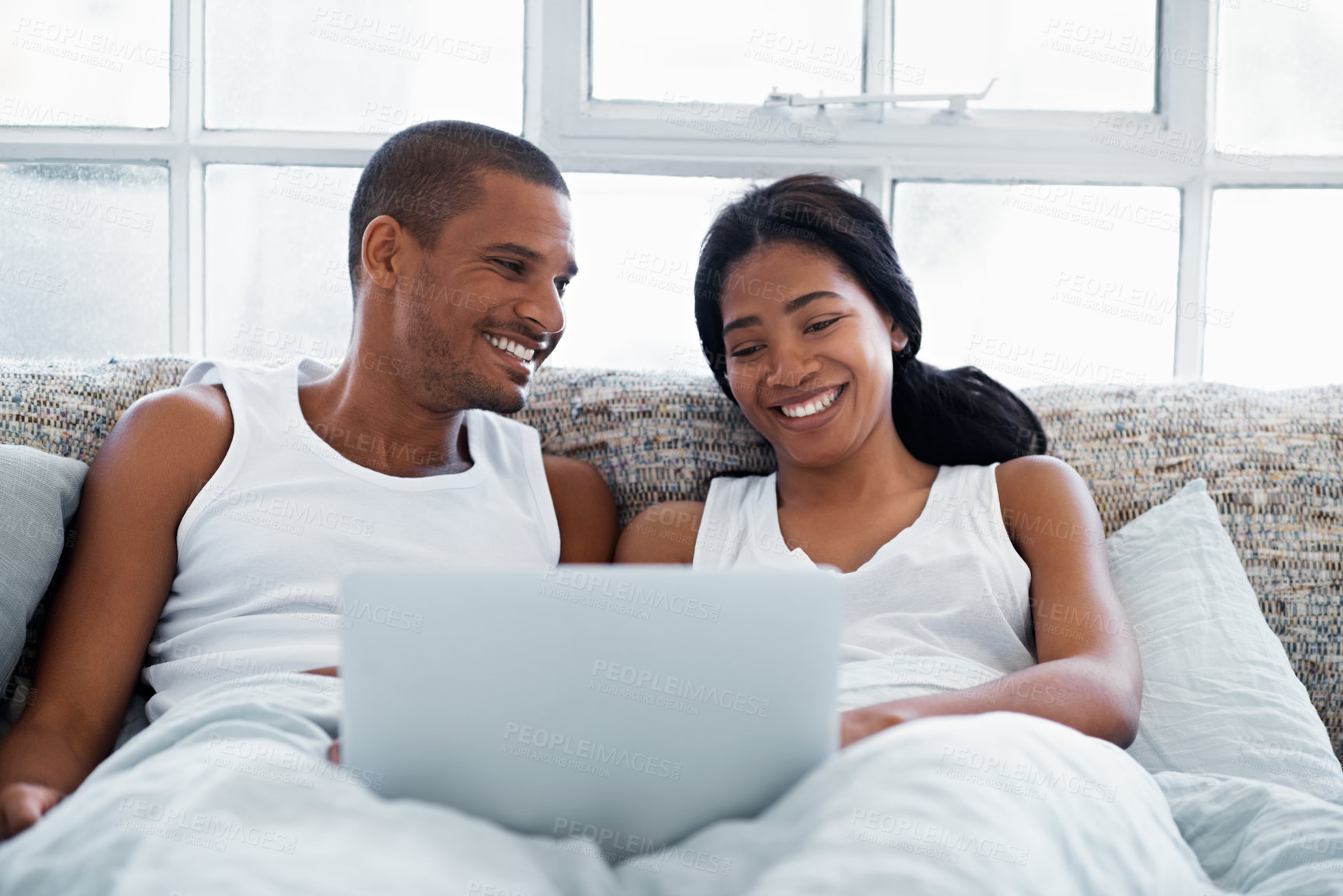 Buy stock photo Laptop, happy and couple in bed in home watching movie, show or series for bonding together. Smile, technology and man with woman in bedroom on computer for streaming film with website subscription.