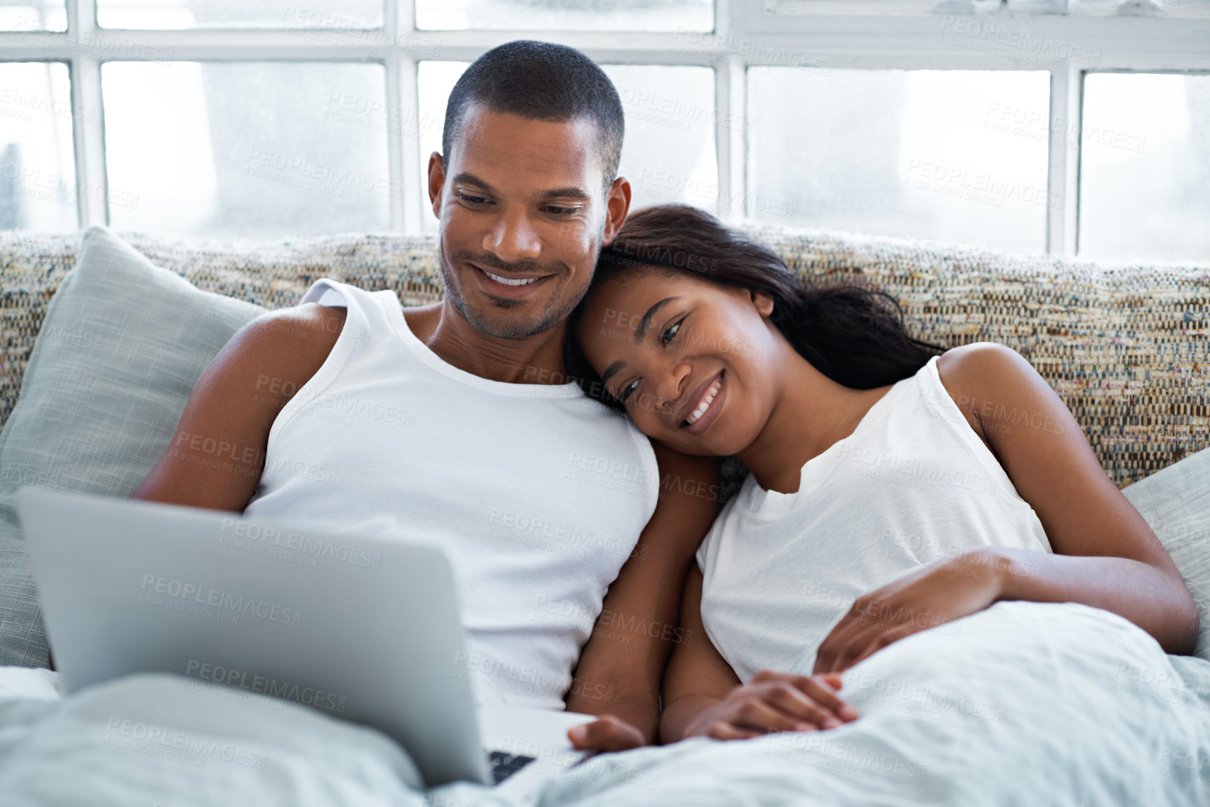Buy stock photo Couple, online and smile with laptop in bedroom, rest and watching movie with subscription in house. Happy people, bonding and streaming film with technology on bed, love or relax with spouse in home