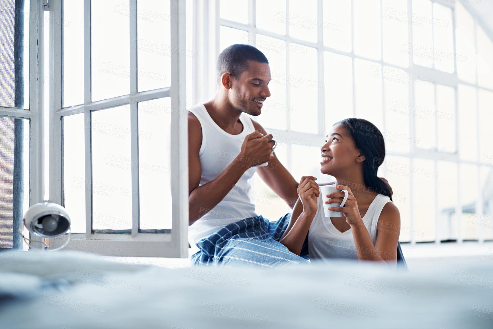 Buy stock photo Talking, home and couple with coffee by window for bonding, conversation and relationship. Happy, morning and man with woman for connection, communication and drink for love, trust or chat on weekend