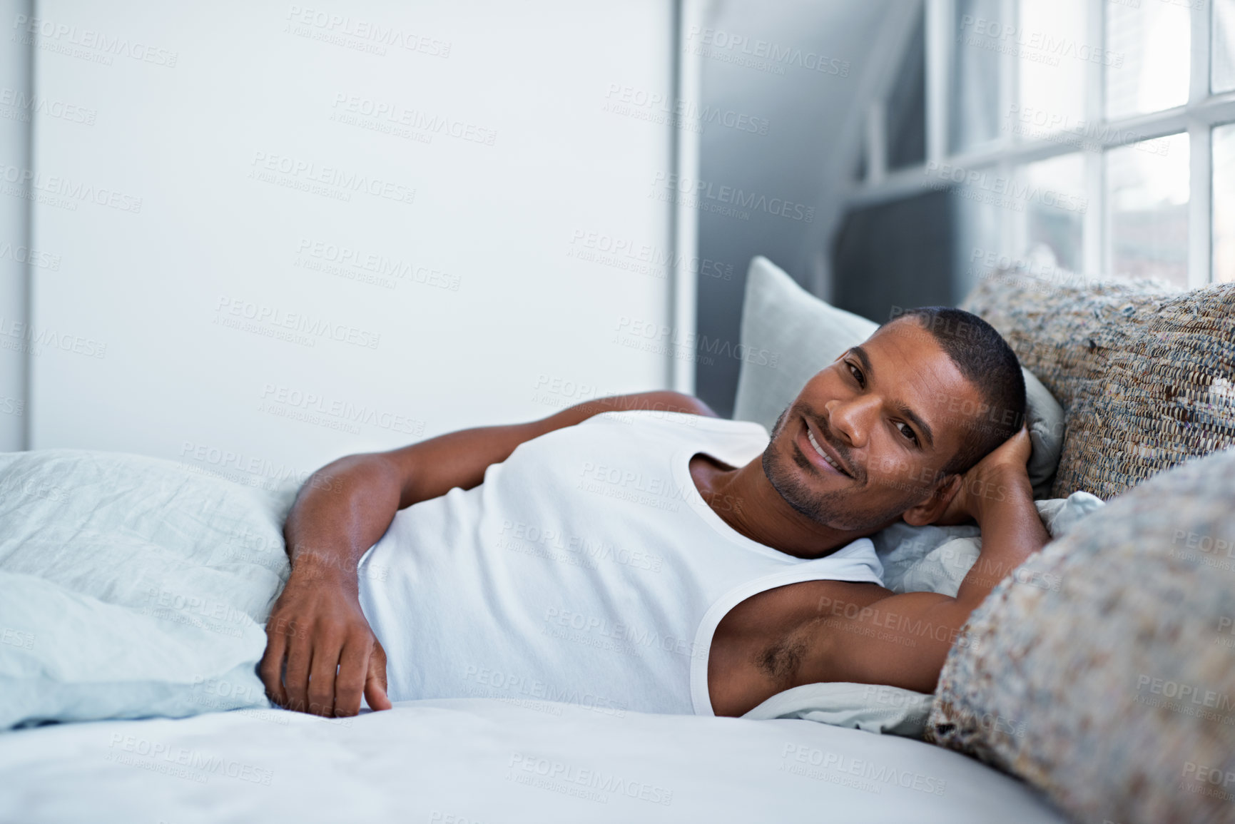 Buy stock photo Portrait, smile and man in bedroom for relax, optimism and positive mindset with peace in home. Happy male person, calm and chill at apartment with wellness, comfort or break for rest in morning