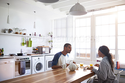 Buy stock photo Cropped shot of a young couple having breakfast in the kitchen