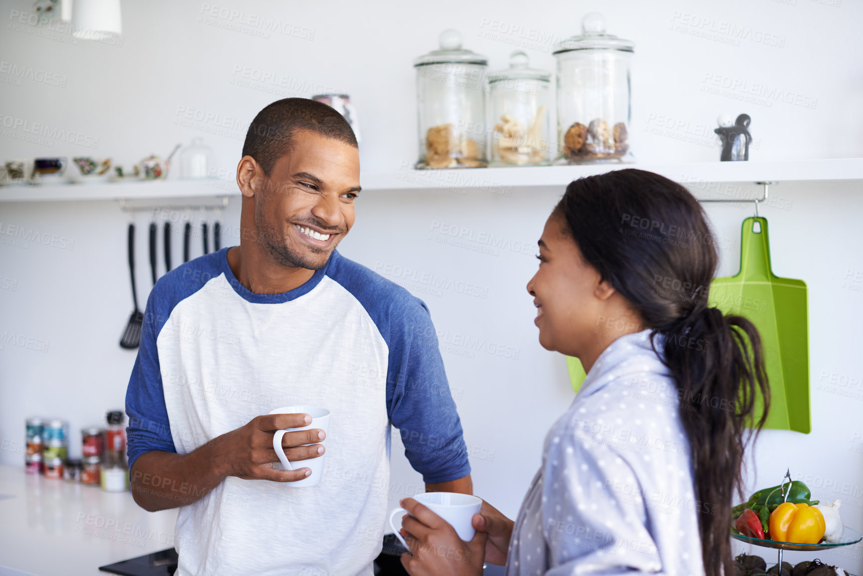 Buy stock photo African couple, coffee and relax with smile in kitchen for bonding, conversation or holiday together. Love, happy man and woman with drink for gossip, support and morning with discussion in house