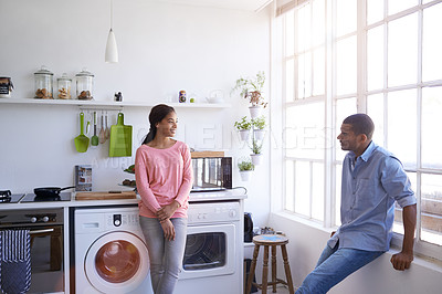 Buy stock photo Cropped shot of a young couple talking in the kitchen