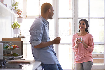 Buy stock photo Cropped shot of a young couple talking in the kitchen
