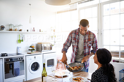 Buy stock photo Cropped shot of a young man serving his wife the dinner he's prepared