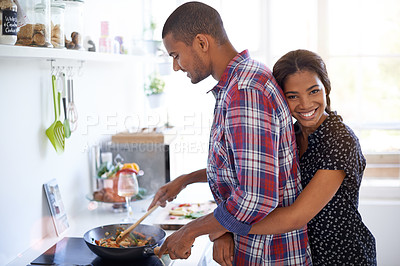 Buy stock photo Cropped shot of a young couple preparing dinner in their kitchen