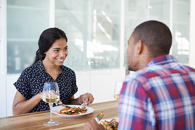 Buy stock photo Cropped shot of a young couple eating dinner in their kitchen