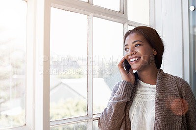 Buy stock photo Cropped shot of a young woman using her cellphone in the kitchen