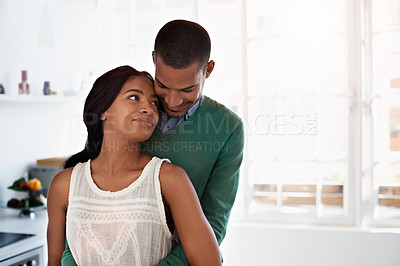 Buy stock photo Cropped shot of an affectionate young couple standing in their kitchen