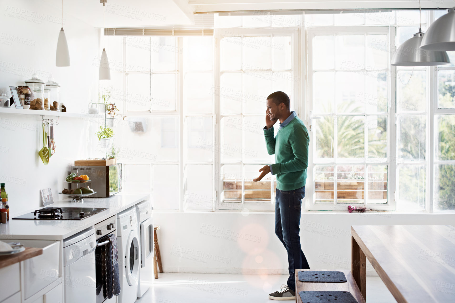 Buy stock photo Phone call, contact and man in kitchen with smile, networking and communication in online chat. Happy, feedback and male person in house with tech, conversation and connection with digital discussion
