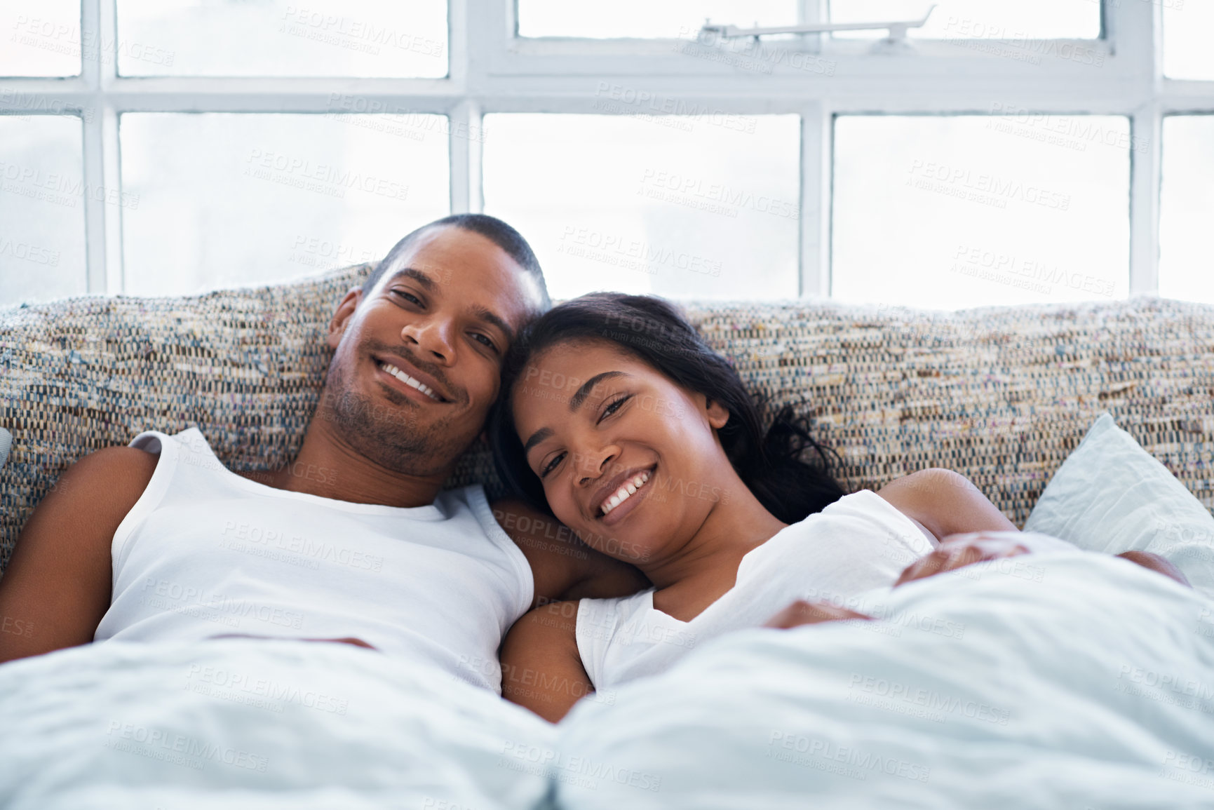 Buy stock photo Couple, bed and portrait with happiness in home, smile and bonding with special moment in bedroom. Man, woman and positive together in house, trust and connection with relax in morning on weekend