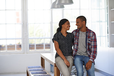 Buy stock photo Shot of a happy couple leaning on their dining table