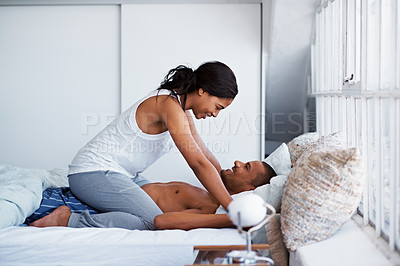 Buy stock photo Shot of a playful couple in bed together