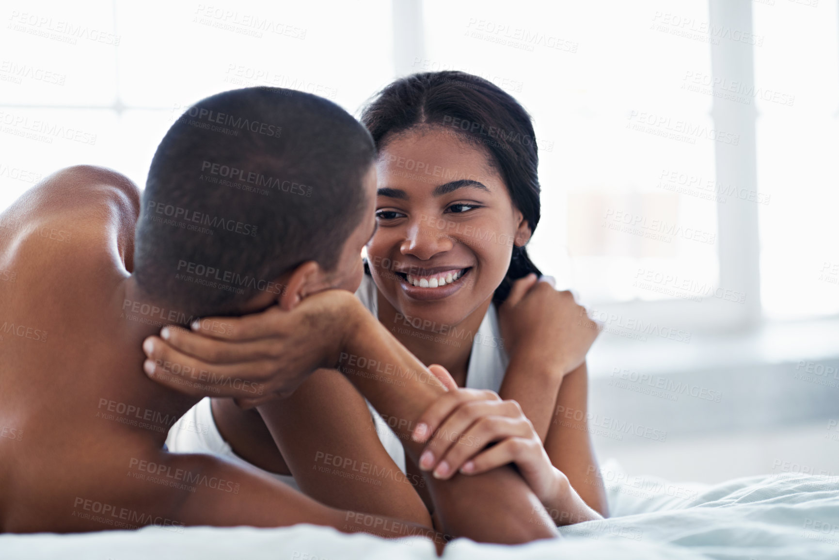 Buy stock photo Relax, happy or couple in bedroom with cuddle, partner comfort or bonding together in weekend break. Smile, love or people in home with chill, tender connection or romantic relationship with day off.