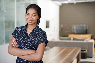Buy stock photo Portrait of a smiling young woman standing with her arms crossed at home