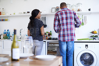 Buy stock photo Shot of a young couple preparing dinner in their kitchen
