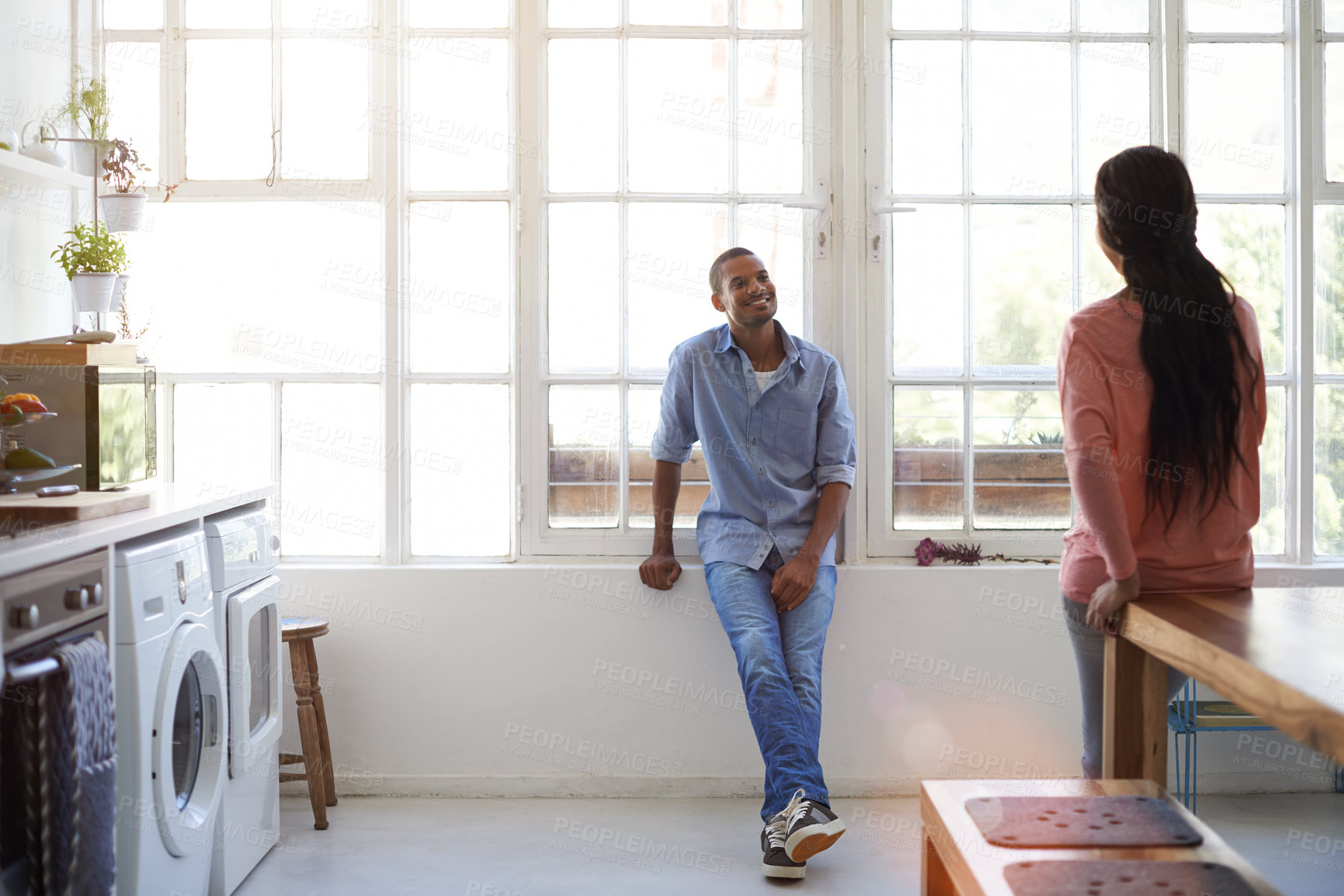Buy stock photo Couple, talking and happy in kitchen at apartment for relationship, understanding and trust. Black man, woman and together in modern home and communication of rent, future and co ownership by window