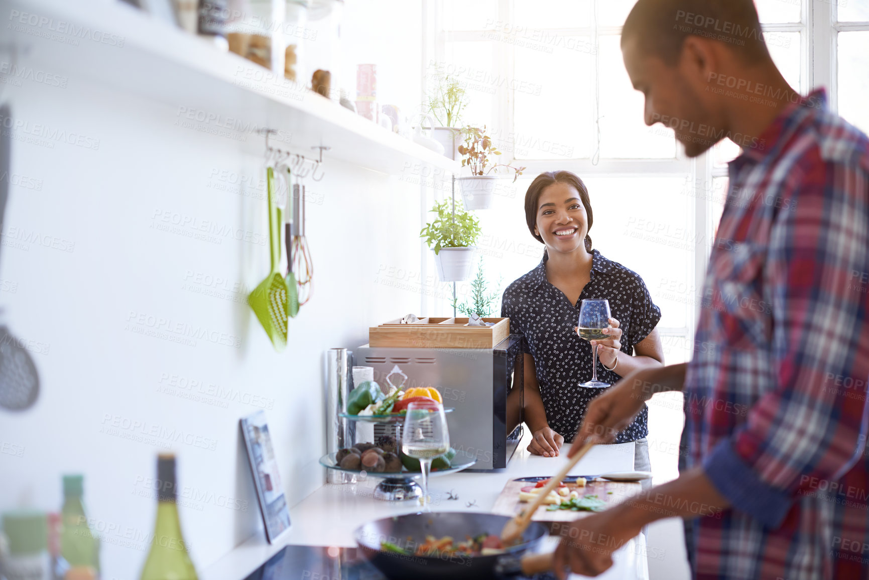 Buy stock photo Wine, happy woman and cooking with couple for love in kitchen, organic food and stir fry with pan. Meal prep on stove, man and partner with alcohol at home for healthy diet, connection and smile