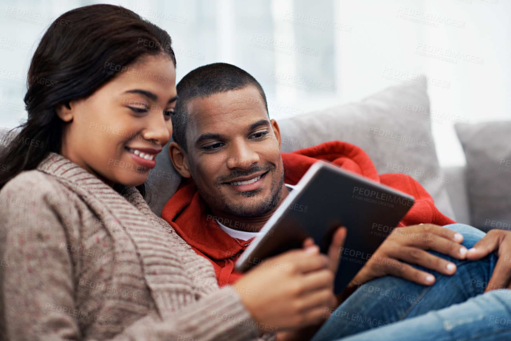 Buy stock photo Relax, bonding and happy couple with tablet on sofa in home for online entertainment together. Man, woman or chilling with technology for holiday, app subscription or streaming service in house