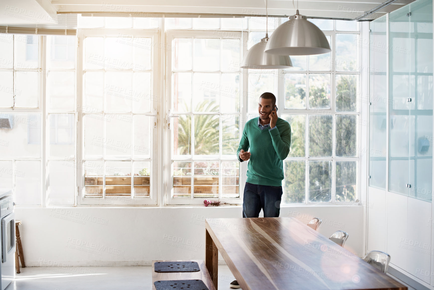 Buy stock photo Smile, phone call and man in home for conversation, remote work project or event planning. Mobile, happy person and talk to contact in kitchen, listen or freelancer networking for venue coordination