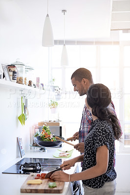 Buy stock photo Shot of a young couple preparing dinner in their kitchen