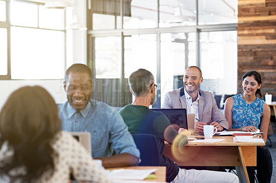 Buy stock photo Shot of a diverse group of professionals working together in a modern office